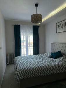 a bedroom with a large bed and a window at Lux Apartman Jovana in Žabljak
