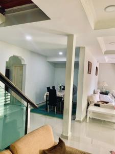 a living room with a couch and a table at Kak Nor Villa in Kuala Terengganu