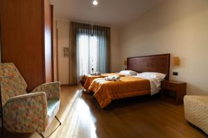 a hotel room with a bed with a cat on it at Le Cupoline in Rome