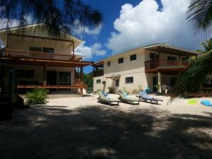 a resort with lounge chairs and a building at Vaiakura Holiday Homes in Rarotonga