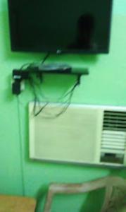 a television on top of a microwave on a wall at Meera Guest House,Cuttack in Cuttack