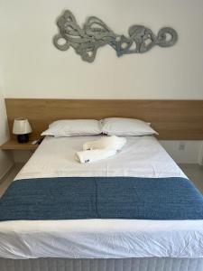 a large white bed with two towels on it at Makia beach Experience in Porto De Galinhas