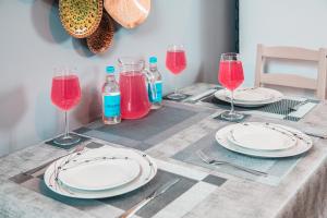 a table with plates and glasses of red wine at Modern and Stylish 1 Bed Flat in High Wycombe