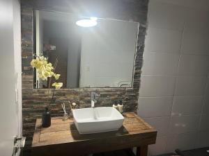 a bathroom with a sink and a mirror at CASA MIA bednbreakfast in Colonia del Sacramento