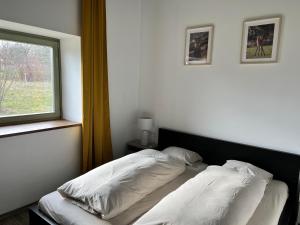 A bed or beds in a room at Aracsa Farm és Vendégház Kis Balaton és termál fürdők