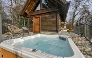 a hot tub on a patio with a house at Awesome Home In Gorkovec With Outdoor Swimming Pool in Letovčan Tomaševečki