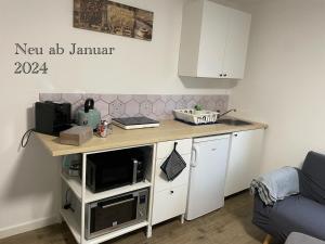 uma cozinha com um balcão e um micro-ondas em Gemütliche 1-Zimmer Wohnung mit eigenem Eingang em Wesseling