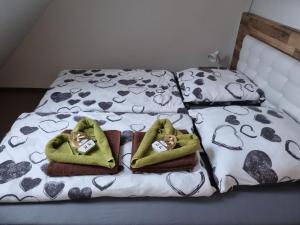 a bed with two babies in towels on it at Maisonette Geiseltal in Braunsbedra