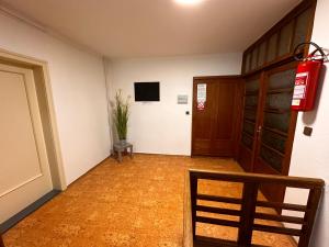 an empty hallway with a door and a potted plant at Penzion Roko in Rokytnice nad Jizerou