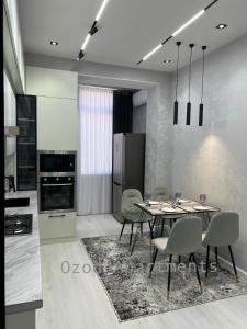 a kitchen and dining room with a table and chairs at 2-roomed apartment close to REGISTAN Ozod Apartments in Samarkand