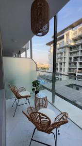 einen Balkon mit Stühlen und einem Tisch auf einem Gebäude in der Unterkunft Modern Home in Al Qurayyah