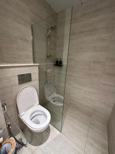 a bathroom with a shower and a toilet at Modern Home in Al Qurayyah
