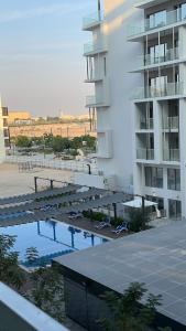 a view of a swimming pool next to a building at Modern Home in Al Qurayyah