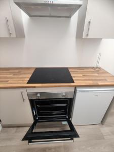 a kitchen with a black and white stove top oven at Adorable 2BR Apartment in The Rock Bury in Bury