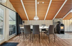 a dining room with a table and chairs at Lovely Home In Aakirkeby With Kitchen in Vester Sømarken