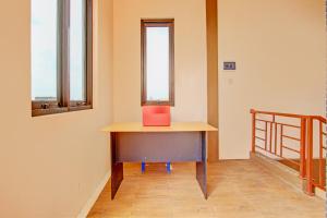 a desk in a room with a red box on it at OYO 93208 Guest House Cemara 2 in Brebes