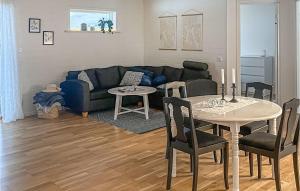 a living room with a couch and a table at Lovely Home In Ydre With Ethernet Internet in Ekäng