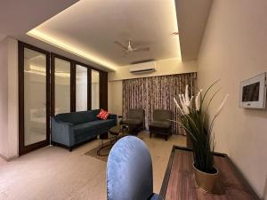 a living room with a couch and a table at 1.5BR Service apartment in BKC by Florastays in Mumbai
