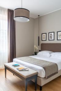 a bedroom with a large bed and a table at Flom Boutique Hotel in Florence