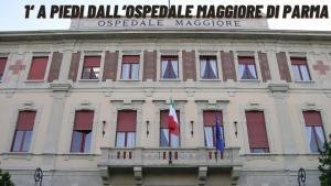 a building with two flags on top of it at G12 B&B l Zona Ospedale Maggiore & Centro l Parking Privato Gratuito in Parma