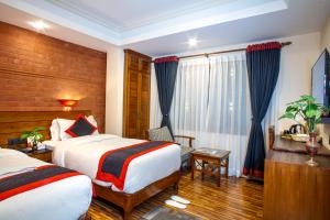 Postel nebo postele na pokoji v ubytování Taleju Boutique Hotel
