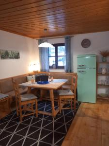 a kitchen with a table and a green refrigerator at S'Rastl direkt mit Bergpanorama in Grundlsee +36 photos