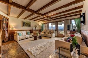 a large living room with couches and a table at Appartement Arolles 701 in La Tzoumaz