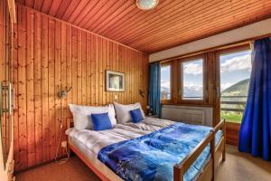 a bedroom with a bed in a wooden wall at Appartement Arolles 701 in La Tzoumaz