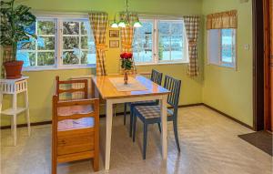 una sala da pranzo con tavolo, sedie e finestre di Stunning Home In Katrineholm With Wi-fi a Katrineholm