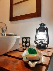 a kitchen counter with a sink and a lantern on it at Elephant Lodge in Udawalawe
