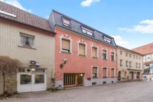 a building on a street next to some buildings at Pfalzzeit - Cozy City Apartment in Landau in der Pfalz