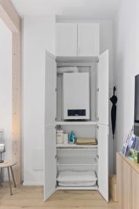 a white closet with a tv in it at Winetime - modern - luxuriös - direkt im Zentrum - Netflix in Landau in der Pfalz