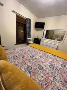 a hotel room with a bed with a colorful carpet at House in Lisburn road in Belfast