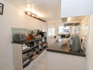 a large kitchen with a counter top with appliances at Winter Cottage in Sudbury