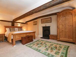 a bedroom with a bed and a fireplace at Winter Cottage in Sudbury