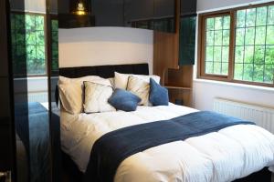 um quarto com uma cama grande e almofadas azuis em Home in Rugby Warwickshire 