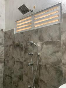 a bathroom with a shower with a glass door at Bethany Homestay in Katunayaka +72 photos