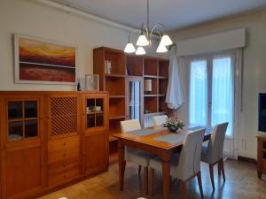 a dining room with a wooden table and chairs at KAIOA .Incluye parking privado. in Hondarribia +36 photos