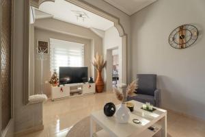a living room with a television and a table at Elvira's houses in Agria