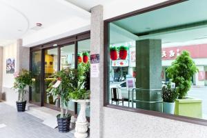 a store front with a window with potted plants at Dealer Hotel in Taipei