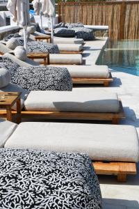 a row of pillows lined up next to a pool at Mykonos Eight in Mýkonos City