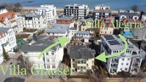 an aerial view of a city with buildings with green arrows at Villa Glaeser in Bansin