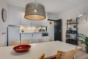 a kitchen with a table with a bowl on it at By the sea - Linen and towels included in Fåborg