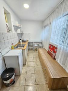 a small kitchen with a sink and a table at Booking Apartments Alone 2 in Zemun