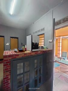a room with a kitchen with a counter top at Miezzan Homestay in Kuala Selangor