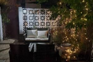a patio with a white couch and some christmas lights at luxury & comfy city break studio in London