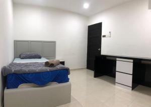 a bedroom with a bed and a flat screen tv at 4 Bedrooms Semi D Muslim Homestay by Mr Homestay Kulim in Kulim