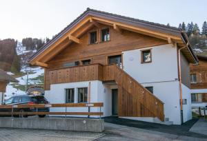 a house with a wooden roof at Ferienchalet Sonne in Adelboden