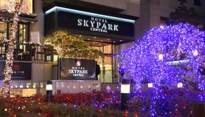 a group of blue christmas trees in front of a building at Hotel Skypark Central Myeongdong in Seoul