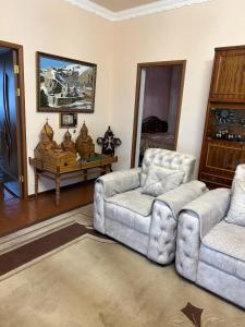 a living room with two chairs and a table at Apartment in Tsaghkadzor